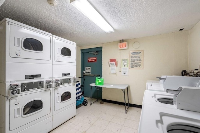 laundry room featuring a textured ceiling, washing machine and dryer, and stacked washer and dryer