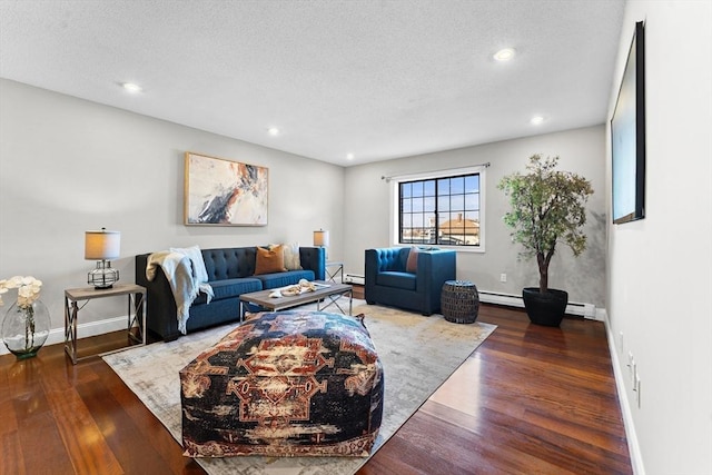 living room featuring baseboard heating, a textured ceiling, and dark hardwood / wood-style flooring