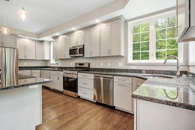 233A Green St Unit A, Boylston, MA 01505 - kitchen with appliances with stainless steel finishes, a sink, decorative light fixtures, dark stone countertops, and recessed lighting
