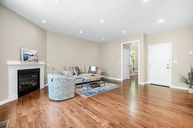 233A Green St Unit A, Boylston, MA 01505 - living area featuring wood finished floors, baseboards, a glass covered fireplace, and recessed lighting