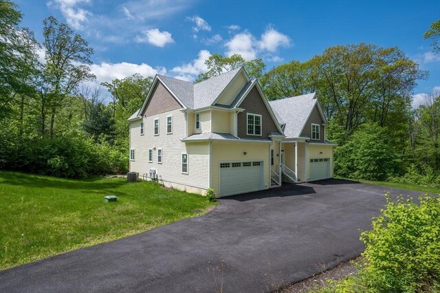 233A Green St Unit A, Boylston, MA 01505 - view of side of property featuring an attached garage, driveway, cooling unit, and a yard