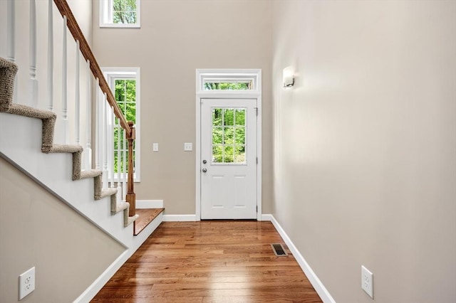 233A Green St Unit A, Boylston, MA 01505 - entryway with healthy amount of natural light, wood finished floors, stairs, and a towering ceiling