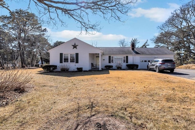 ranch-style house with a garage and a front yard