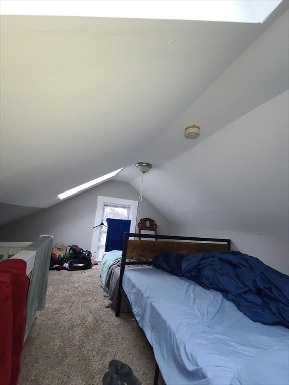 bedroom featuring carpet floors and vaulted ceiling