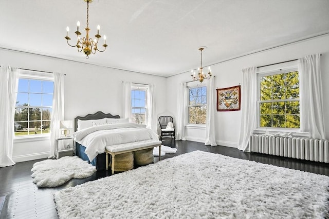 824 Tucker Rd, Dartmouth, MA 02747 - bedroom with a chandelier, radiator heating unit, baseboards, and multiple windows