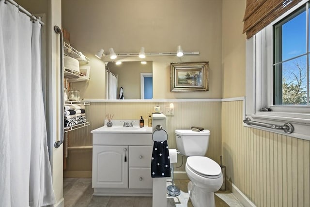 824 Tucker Rd, Dartmouth, MA 02747 - bathroom featuring a wainscoted wall, toilet, tile patterned floors, and vanity