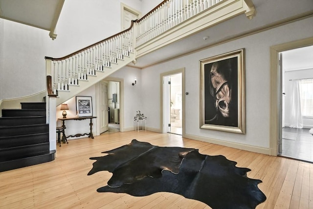 824 Tucker Rd, Dartmouth, MA 02747 - living area featuring hardwood / wood-style flooring, stairway, baseboards, and a high ceiling