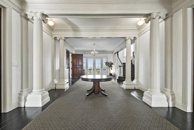 824 Tucker Rd, Dartmouth, MA 02747 - hallway with decorative columns, dark wood-style flooring, french doors, ornamental molding, and a chandelier