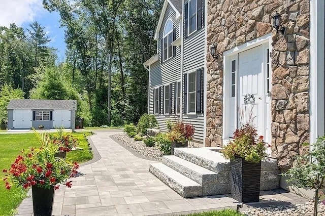 exterior space featuring an outdoor structure and stone siding