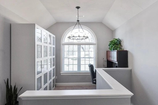 stairs featuring visible vents, baseboards, a notable chandelier, and vaulted ceiling