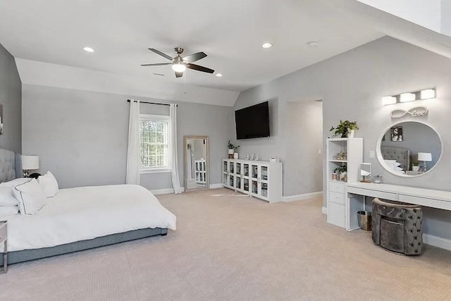 bedroom featuring baseboards, lofted ceiling, and light carpet