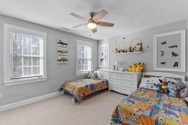 bedroom featuring carpet floors, a ceiling fan, baseboards, and visible vents