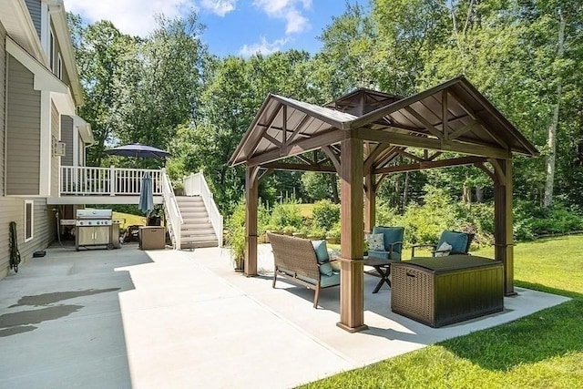 view of patio / terrace with stairs, a gazebo, a wooden deck, grilling area, and outdoor lounge area