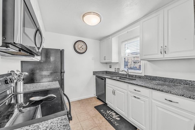 kitchen featuring stainless steel microwave, range with electric cooktop, dishwasher, white cabinetry, and a sink