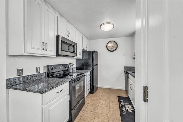 kitchen featuring a textured ceiling, white cabinetry, black appliances, and baseboards