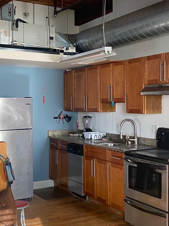 kitchen featuring dark wood-type flooring, sink, and appliances with stainless steel finishes