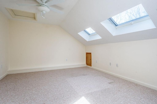 additional living space with lofted ceiling, baseboards, and carpet