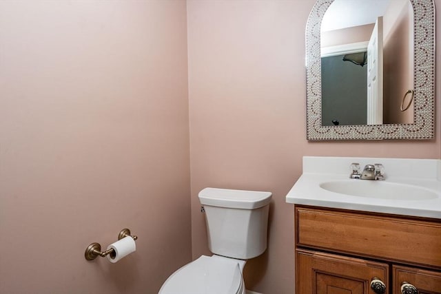 half bathroom featuring vanity and toilet