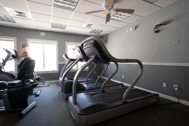 workout area with visible vents, baseboards, and a drop ceiling