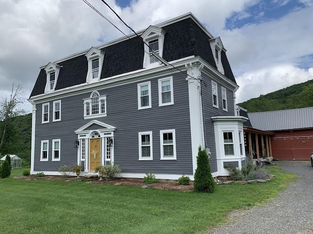 295 Jacksonville Rd, Colrain, MA 01340 - victorian home with mansard roof, roof with shingles, and a front lawn