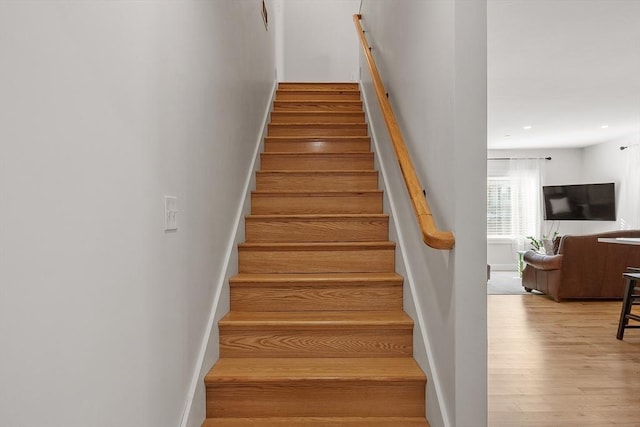 staircase featuring hardwood / wood-style flooring