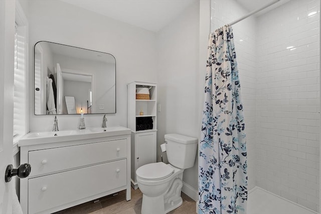 bathroom with vanity, curtained shower, wood-type flooring, and toilet