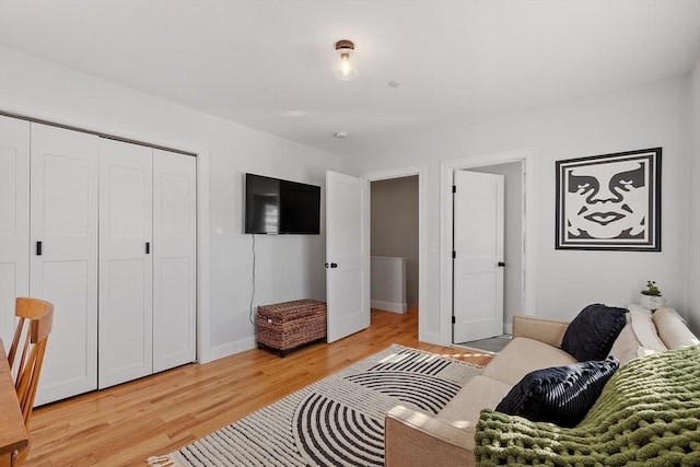 bedroom with a closet and light hardwood / wood-style flooring