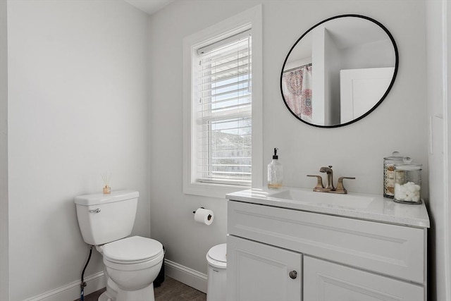 bathroom featuring vanity, hardwood / wood-style floors, and toilet