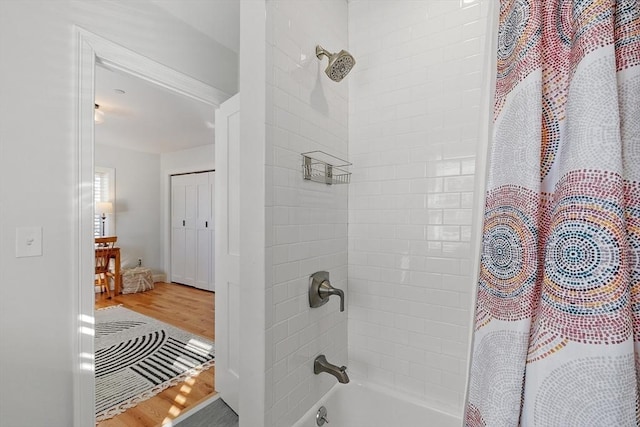 bathroom featuring wood-type flooring and shower / tub combo with curtain