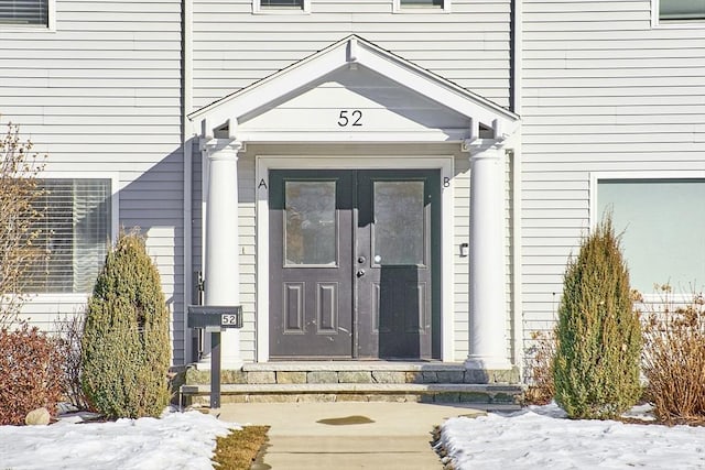 view of snow covered property entrance