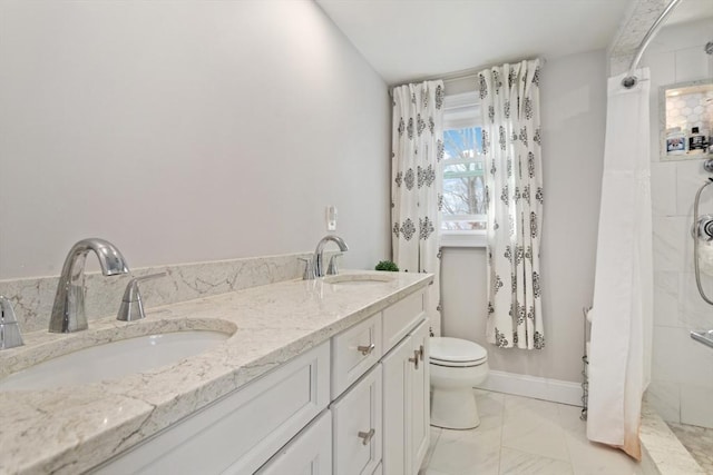 bathroom featuring tiled shower, vanity, and toilet