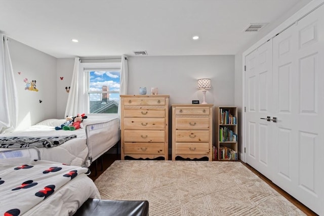 bedroom featuring hardwood / wood-style flooring and a closet