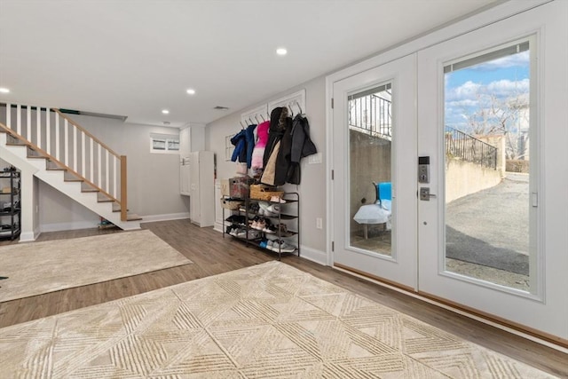 mudroom with hardwood / wood-style flooring and french doors