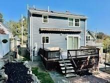 rear view of house featuring a deck