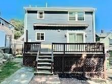 rear view of property with a wooden deck