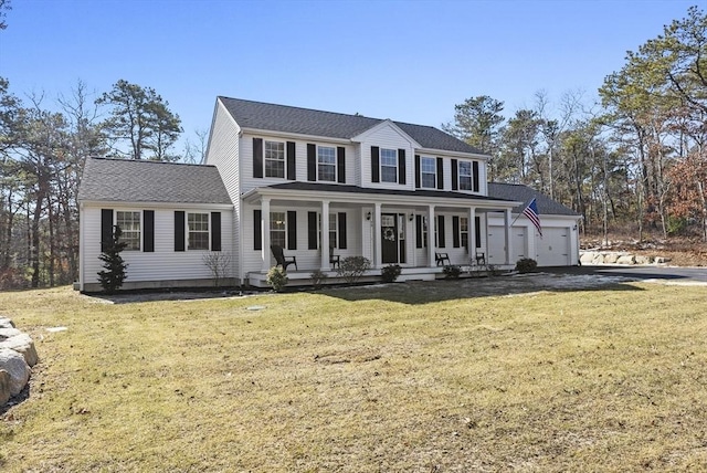 colonial house with a front lawn, covered porch, a garage, and roof with shingles