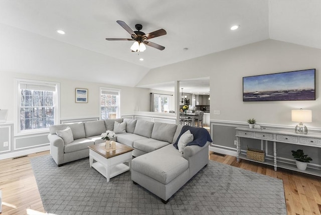 living room featuring visible vents, recessed lighting, lofted ceiling, and wood finished floors