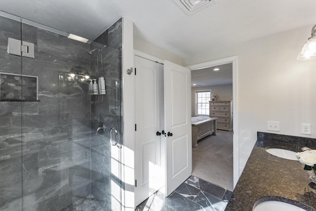 bathroom with a sink, visible vents, marble finish floor, and a shower stall