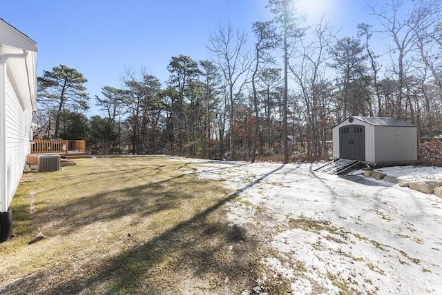 view of yard with a storage shed, cooling unit, an outdoor structure, and a wooden deck