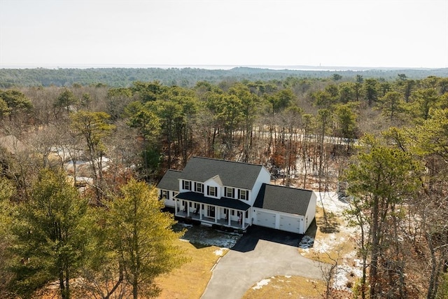 birds eye view of property with a forest view