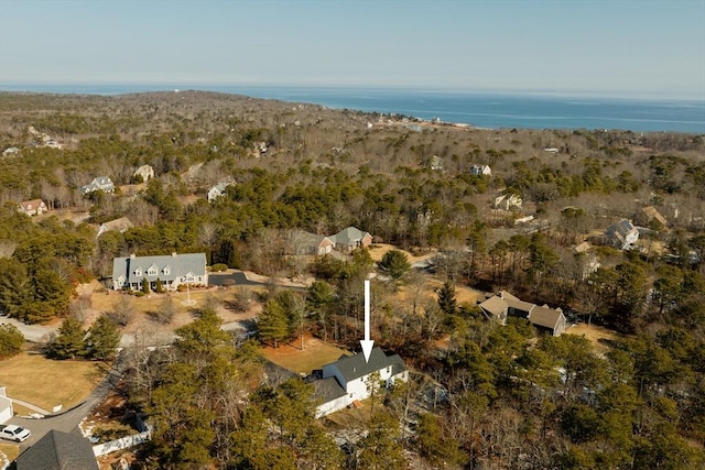 aerial view with a wooded view and a water view