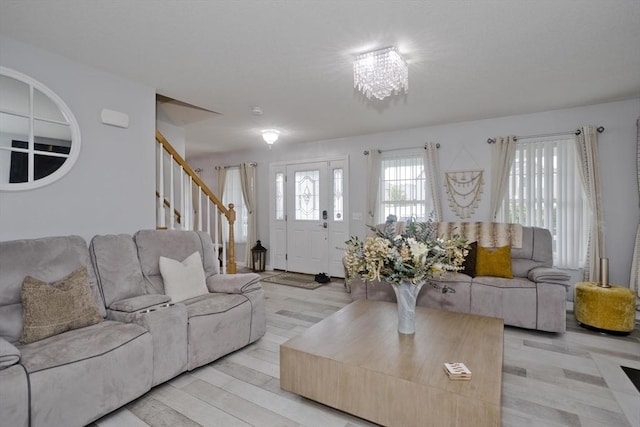 210 Naismith, Springfield, MA 01104 - living room with stairs, light wood-style floors, and a chandelier