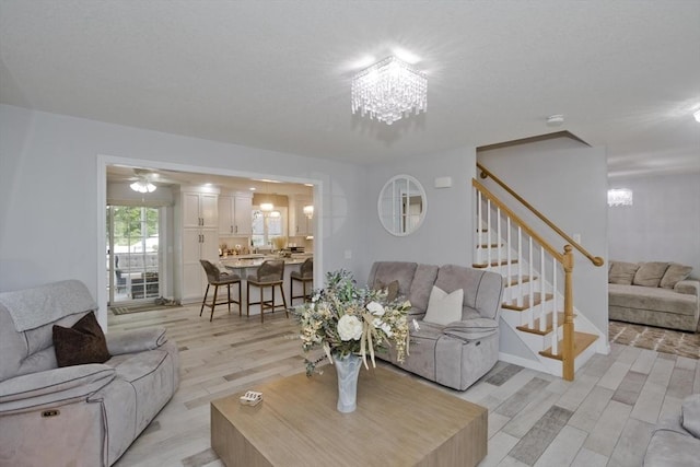 210 Naismith, Springfield, MA 01104 - living room with a chandelier, light wood-type flooring, and stairs