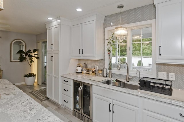 210 Naismith, Springfield, MA 01104 - kitchen with wine cooler, white cabinetry, backsplash, and recessed lighting