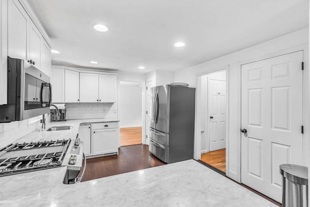 12 Blueberry Ln, Hudson, MA 01749 - kitchen featuring appliances with stainless steel finishes, a sink, white cabinets, recessed lighting, and backsplash