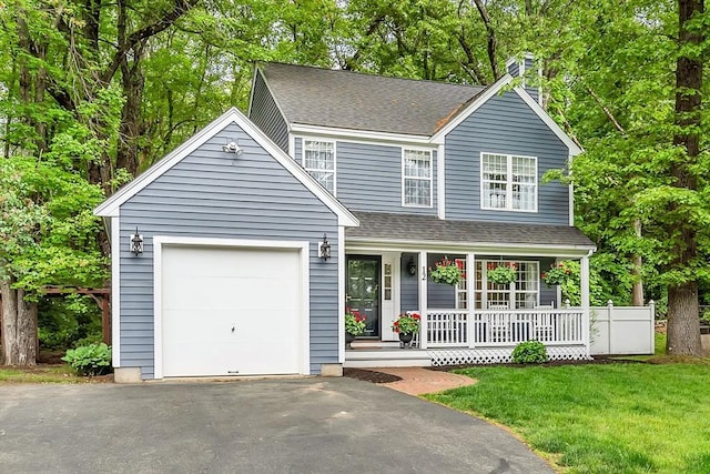 12 Blueberry Ln, Hudson, MA 01749 - view of front facade featuring a porch, a chimney, asphalt driveway, a front lawn, and roof with shingles