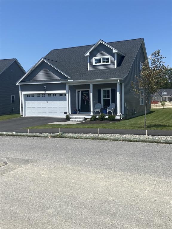 8 Salisbury Hill Blvd Unit 76, Worcester, MA 01609 - view of front facade with a garage, a porch, a front yard, a shingled roof, and asphalt driveway