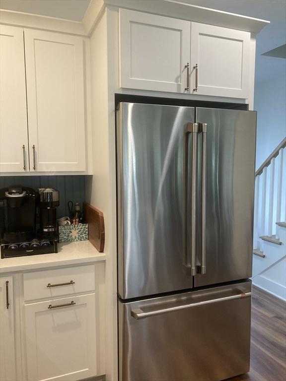 8 Salisbury Hill Blvd Unit 76, Worcester, MA 01609 - kitchen with high end refrigerator, white cabinetry, dark wood-type flooring, and light countertops