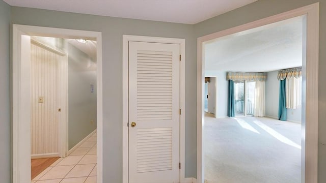 corridor with light colored carpet