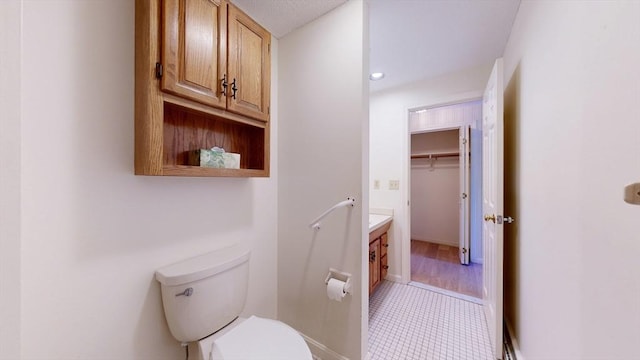 bathroom featuring vanity, tile patterned flooring, and toilet